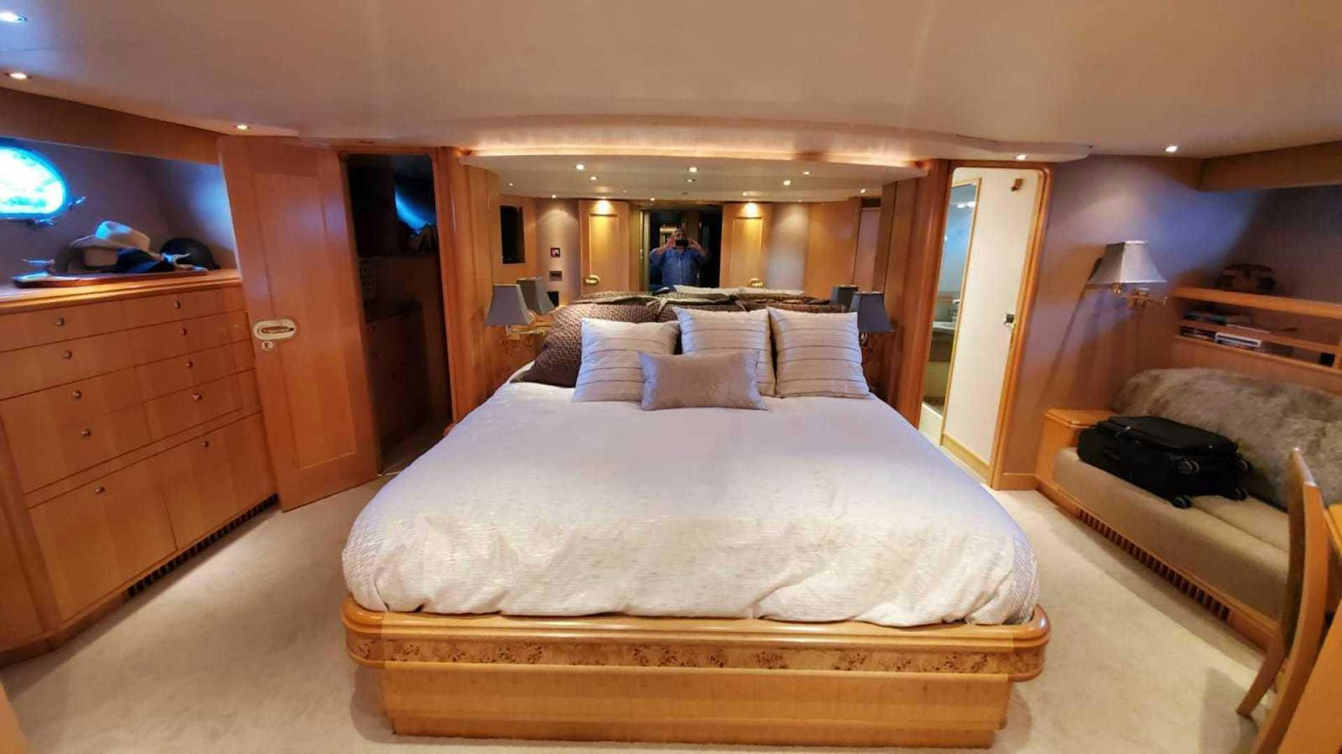 a bedroom with a bed and a television aboard LA LA LAND Yacht for Sale