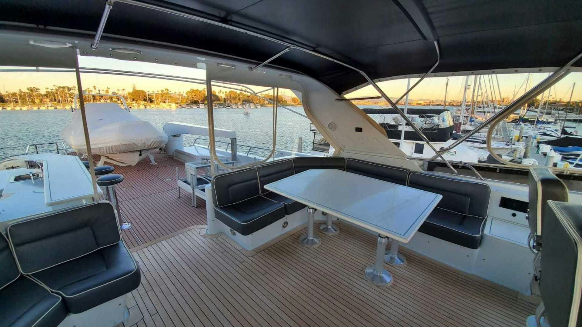 a deck with a deck and chairs aboard LA LA LAND Yacht for Sale