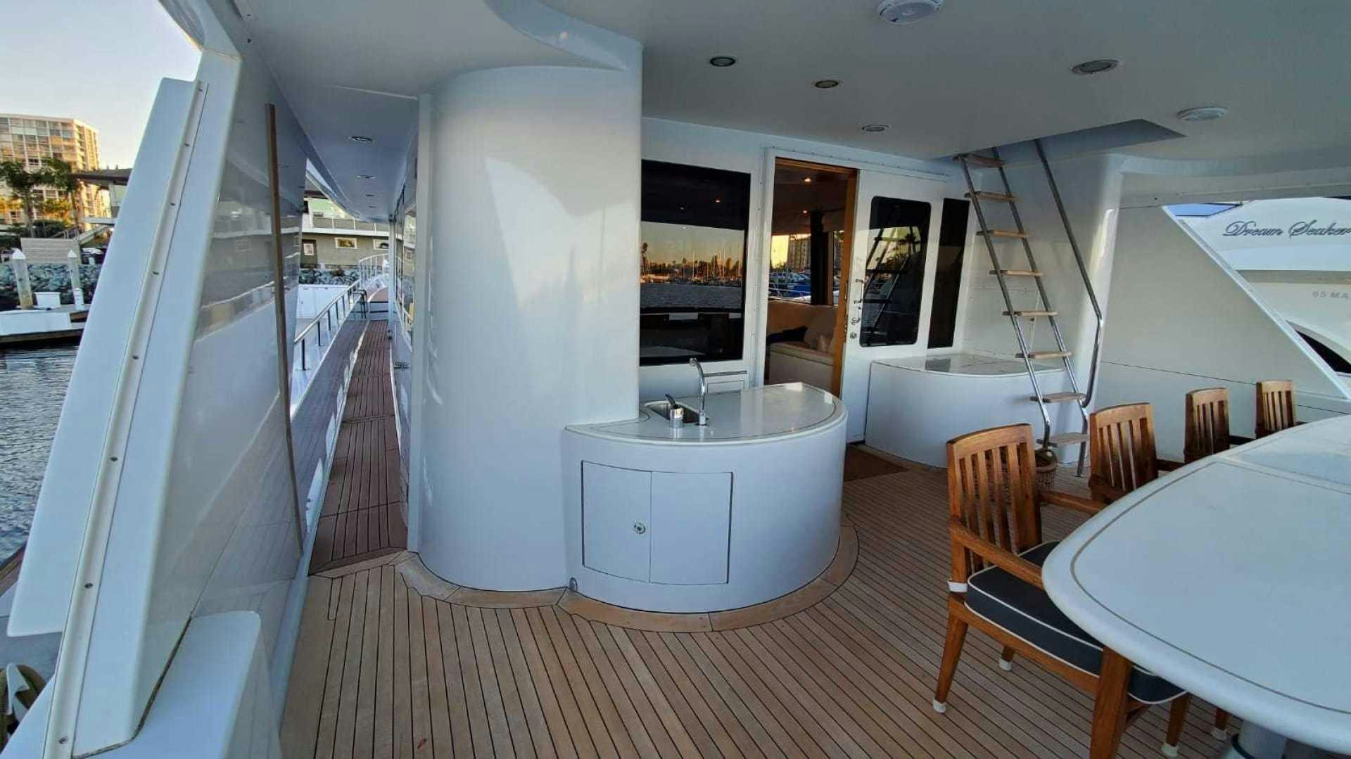a room with a table and chairs aboard LA LA LAND Yacht for Sale
