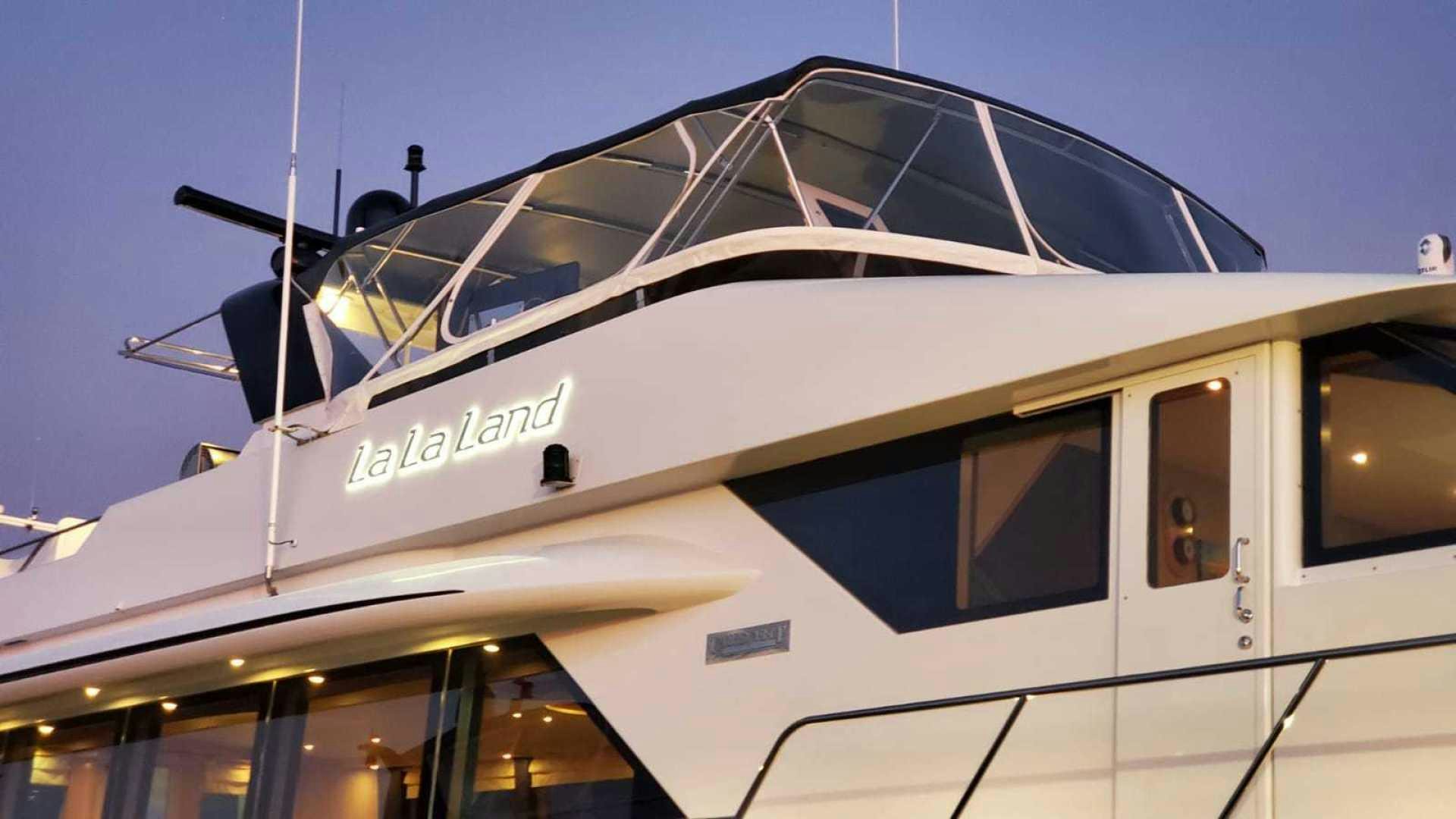 a white yacht with a blue roof aboard LA LA LAND Yacht for Sale