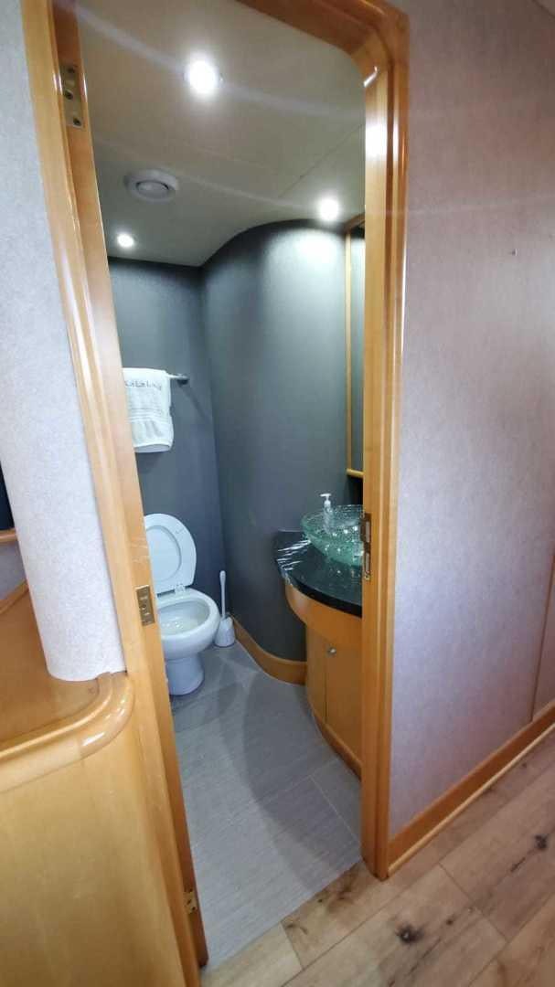a bathroom with a toilet and a mirror aboard LA LA LAND Yacht for Sale