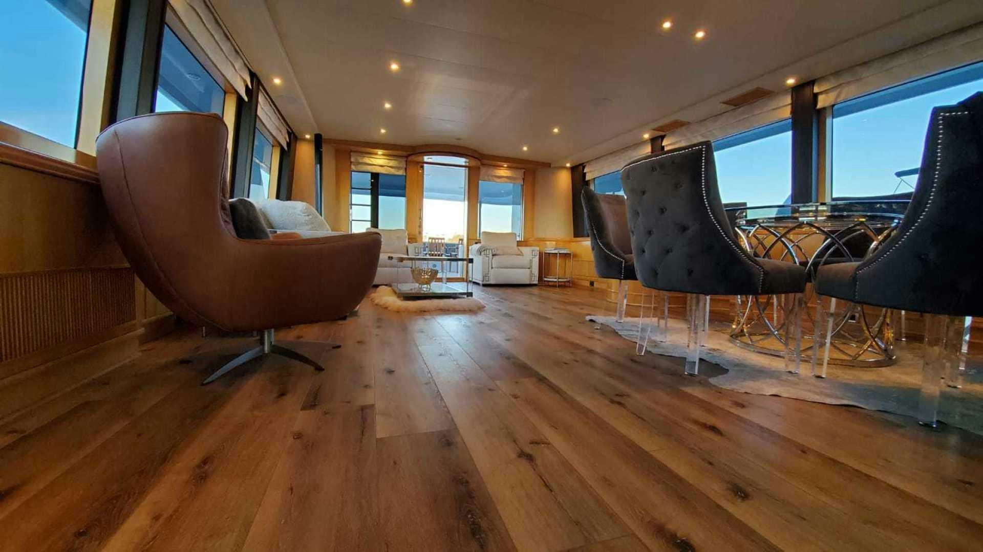 a room with a chair and a table and a chair aboard LA LA LAND Yacht for Sale