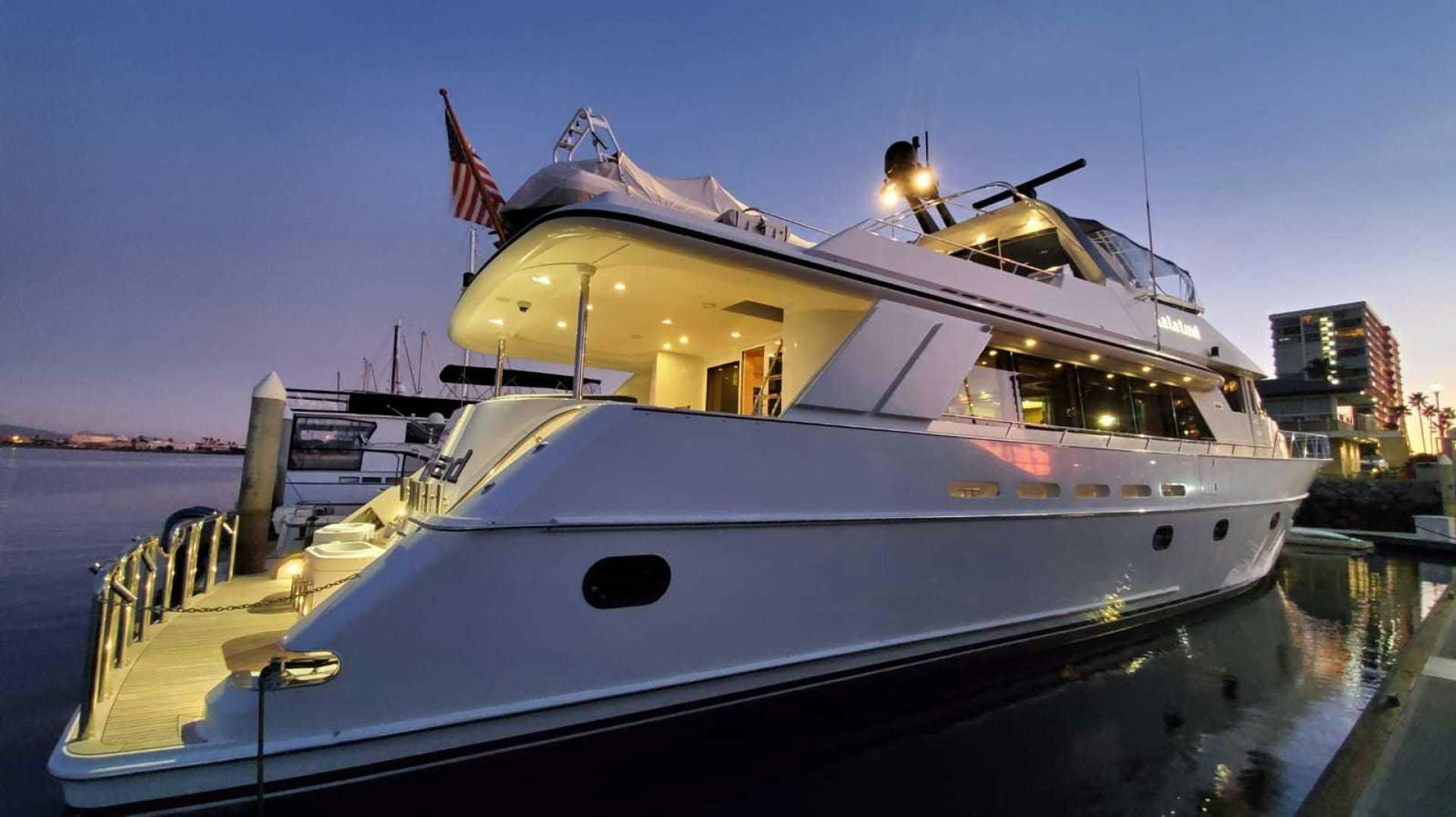 a large white boat with a flag on top aboard LA LA LAND Yacht for Sale