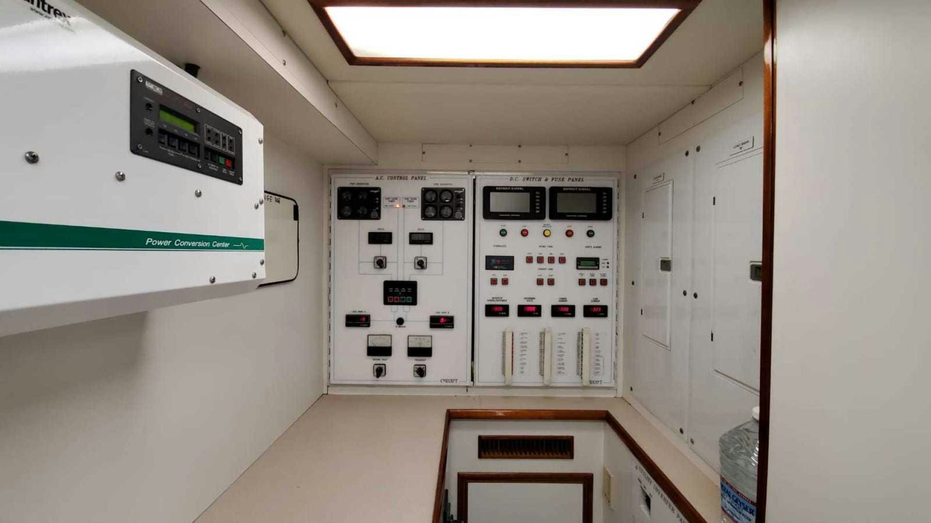 a room with white cabinets and electronic equipment aboard LA LA LAND Yacht for Sale