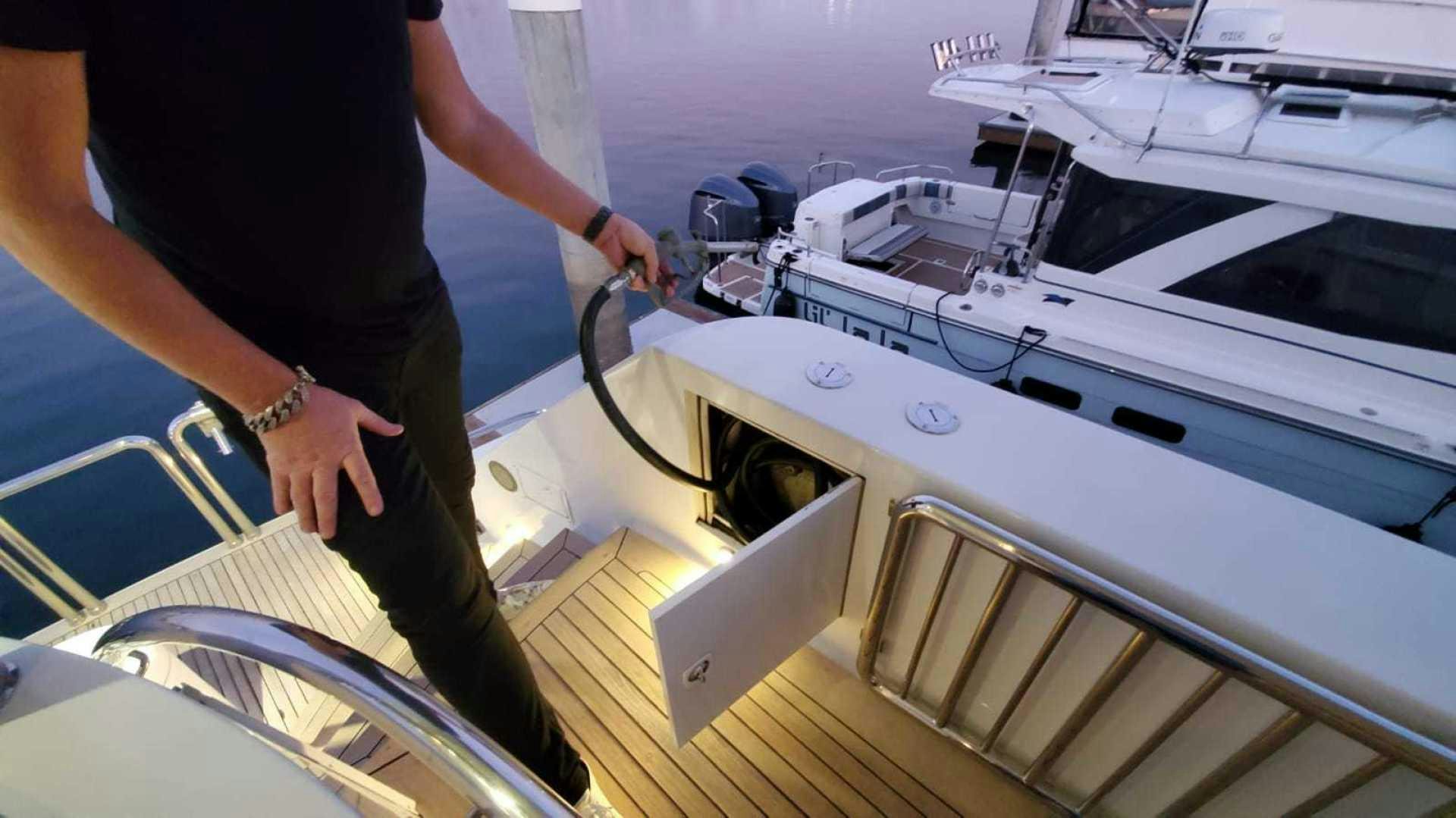 a man holding a fishing rod aboard LA LA LAND Yacht for Sale