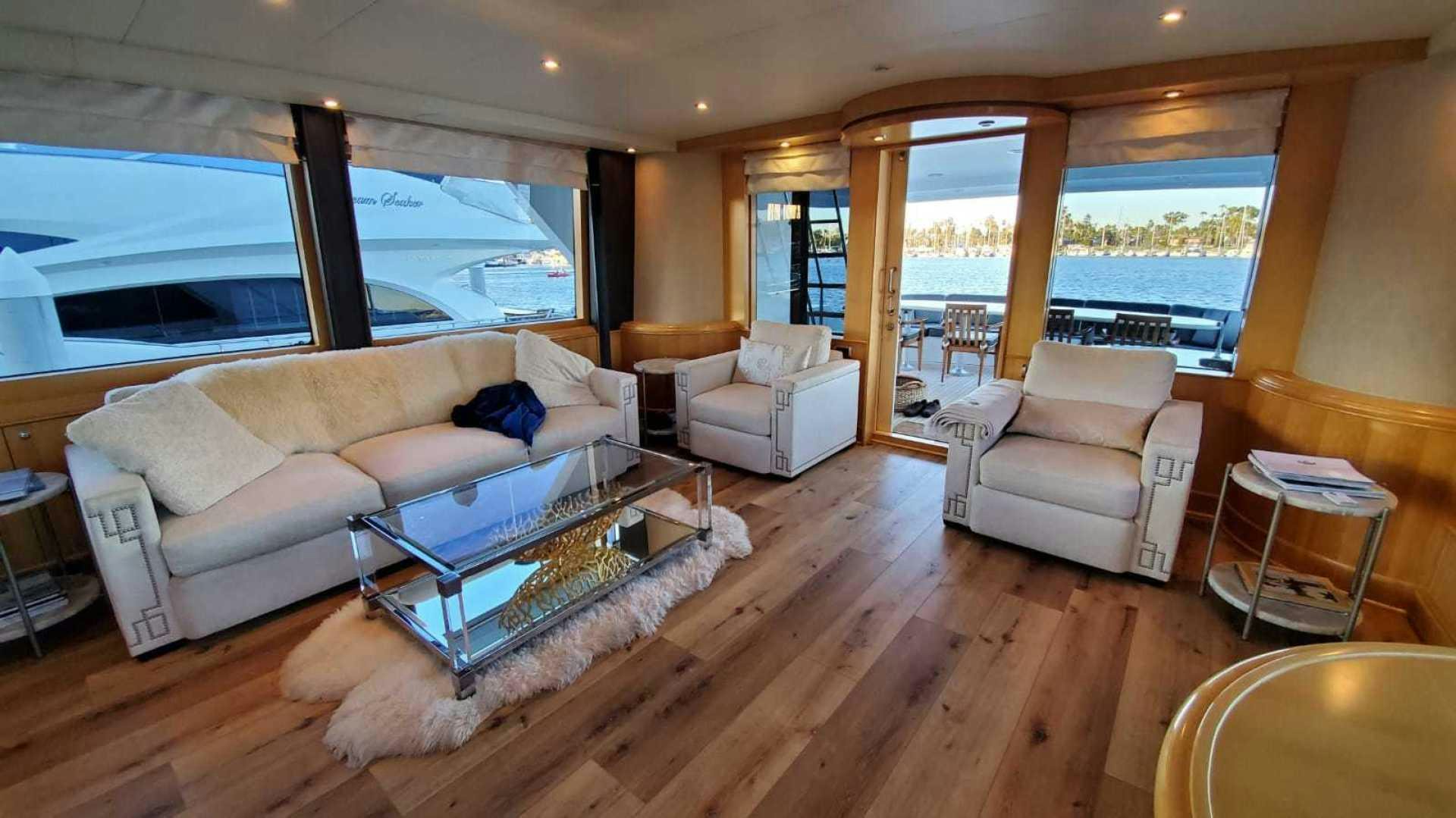 a living room with a large window aboard LA LA LAND Yacht for Sale