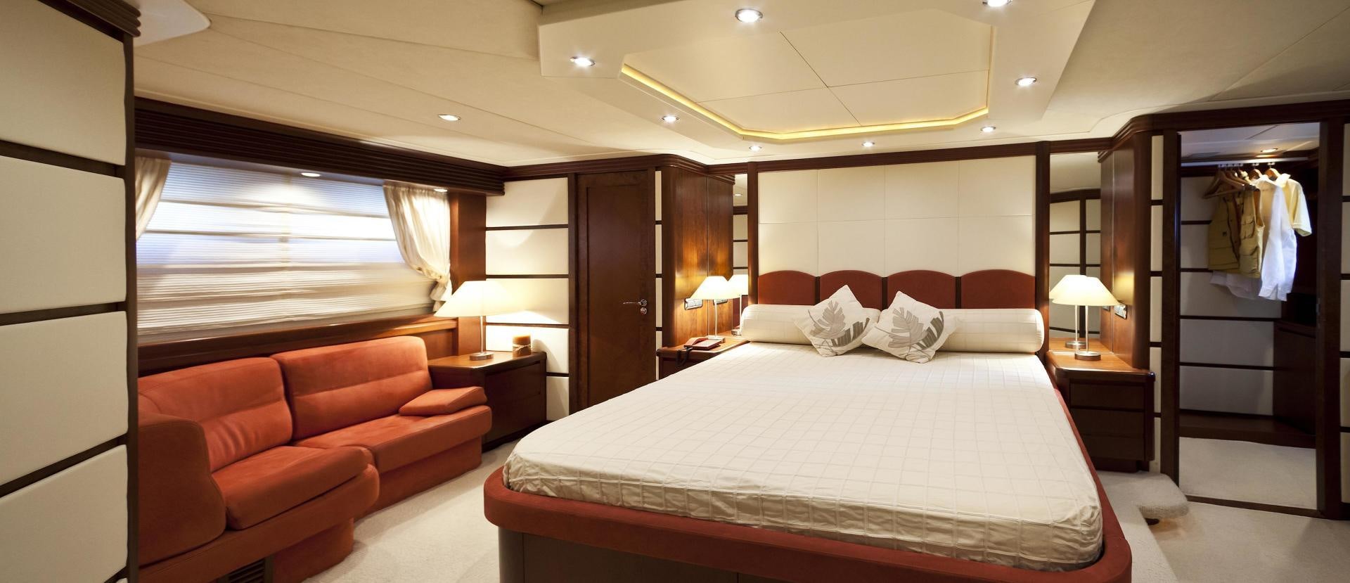 a hotel room with a bed and a couch aboard LADY MOH Yacht for Sale