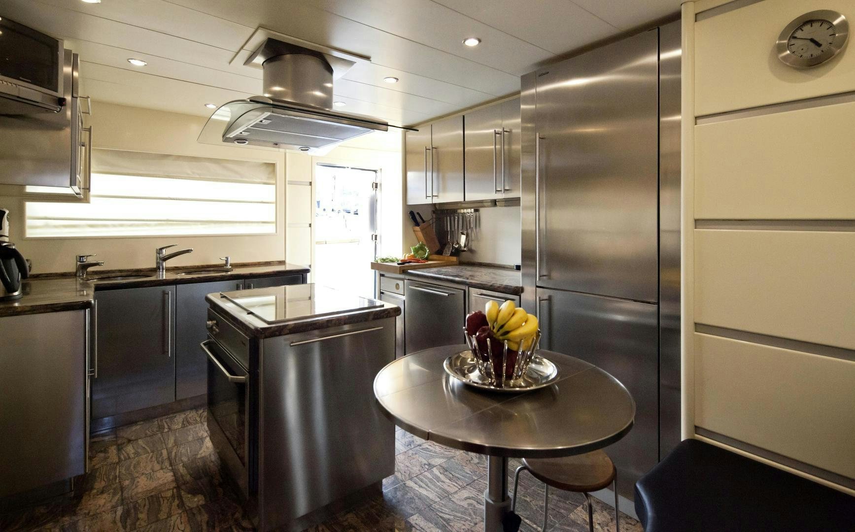 a kitchen with a stainless steel refrigerator aboard LADY MOH Yacht for Sale