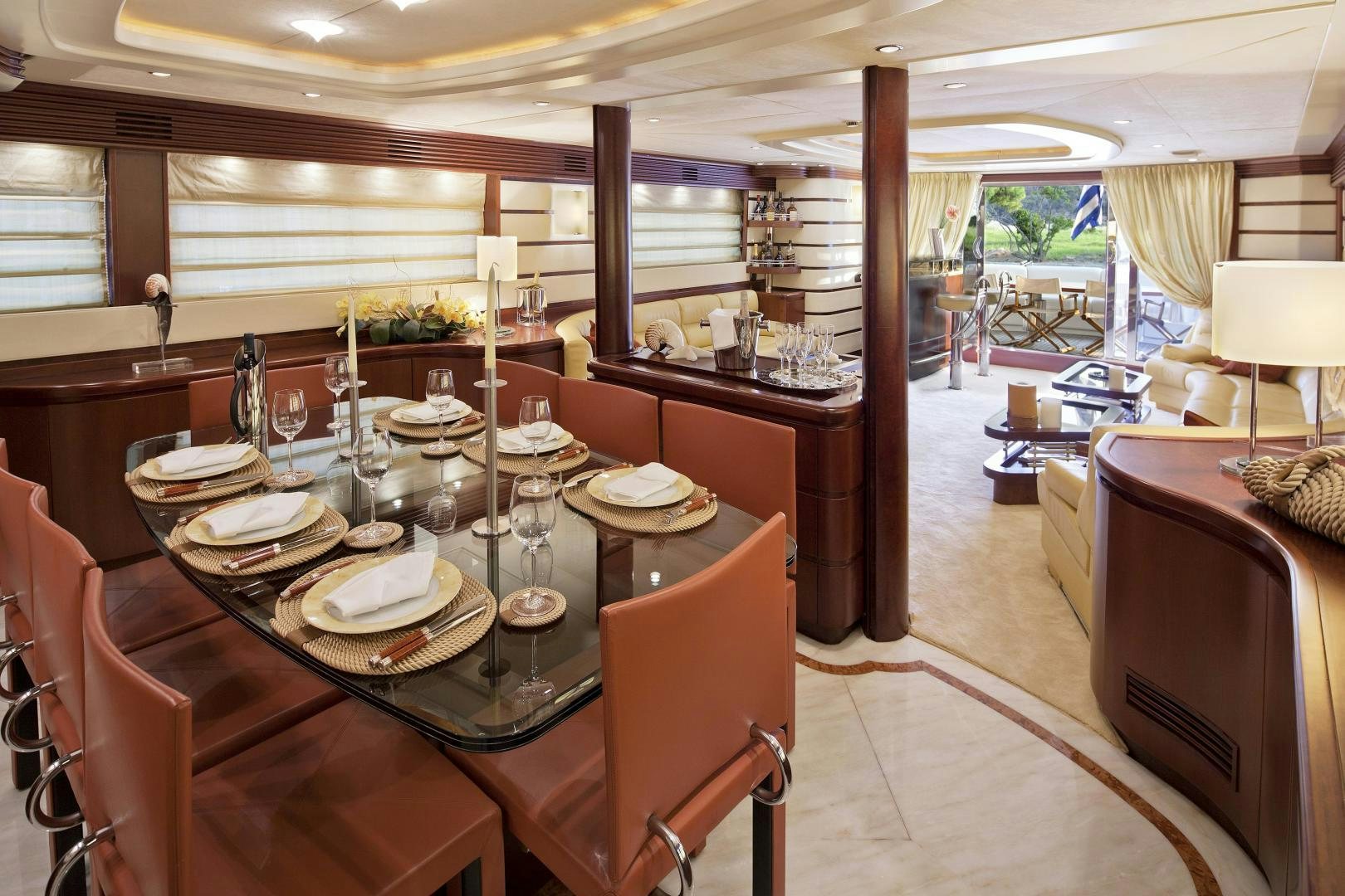 a dining table with plates and glasses aboard LADY MOH Yacht for Sale