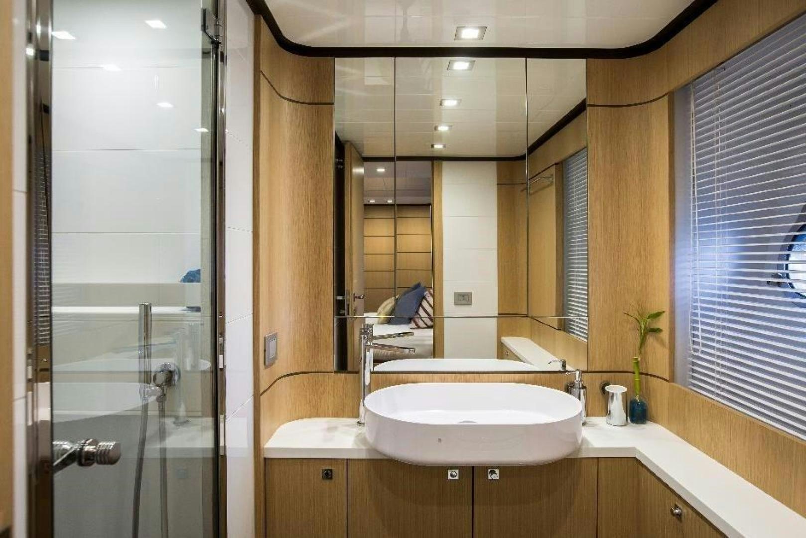 a bathroom with a large mirror aboard HAPPY BLUE II Yacht for Sale