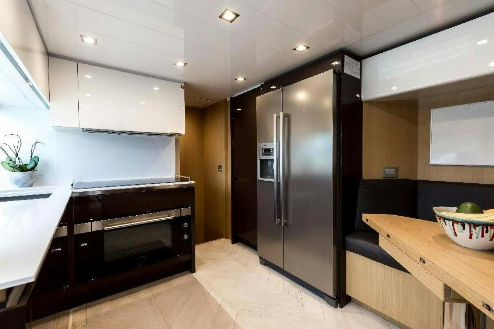a kitchen with a stainless steel refrigerator aboard HAPPY BLUE II Yacht for Sale