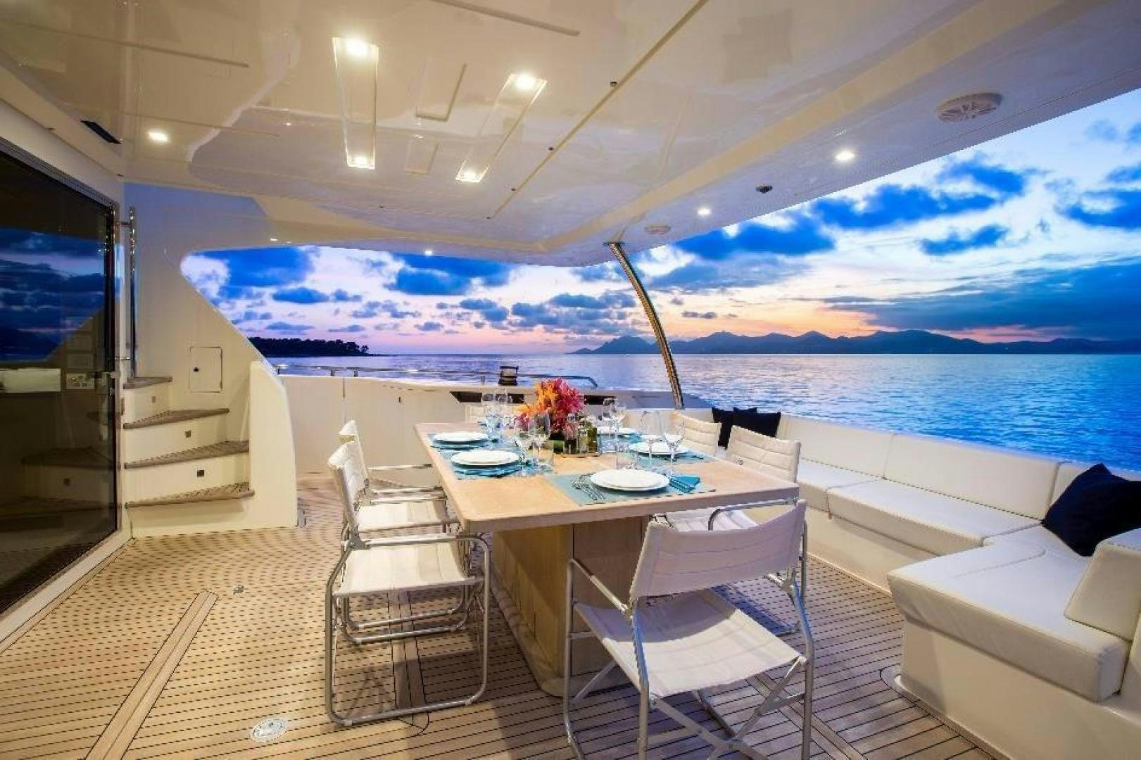 a room with a table and chairs aboard HAPPY BLUE II Yacht for Sale