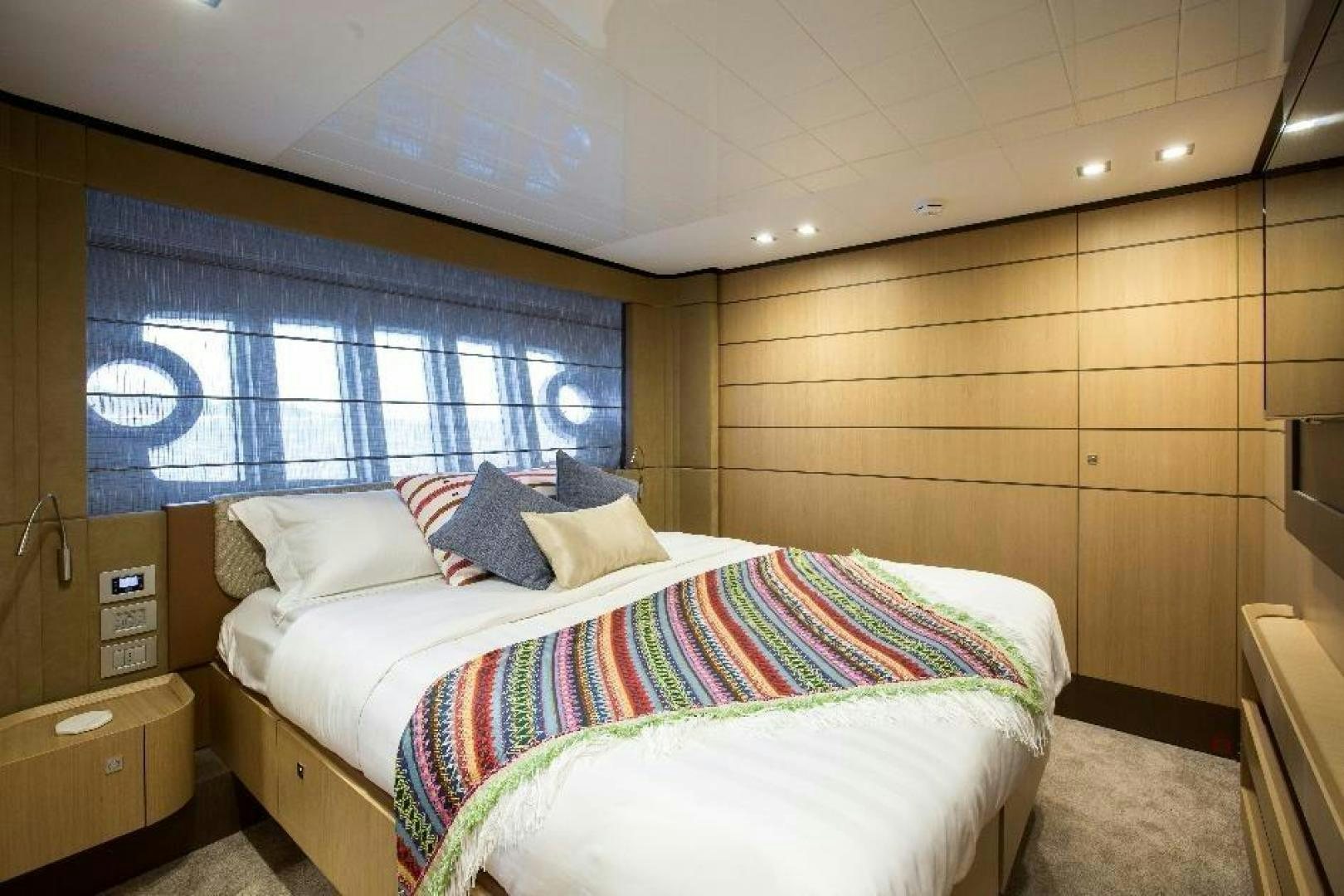 a room with a bed and a window aboard HAPPY BLUE II Yacht for Sale