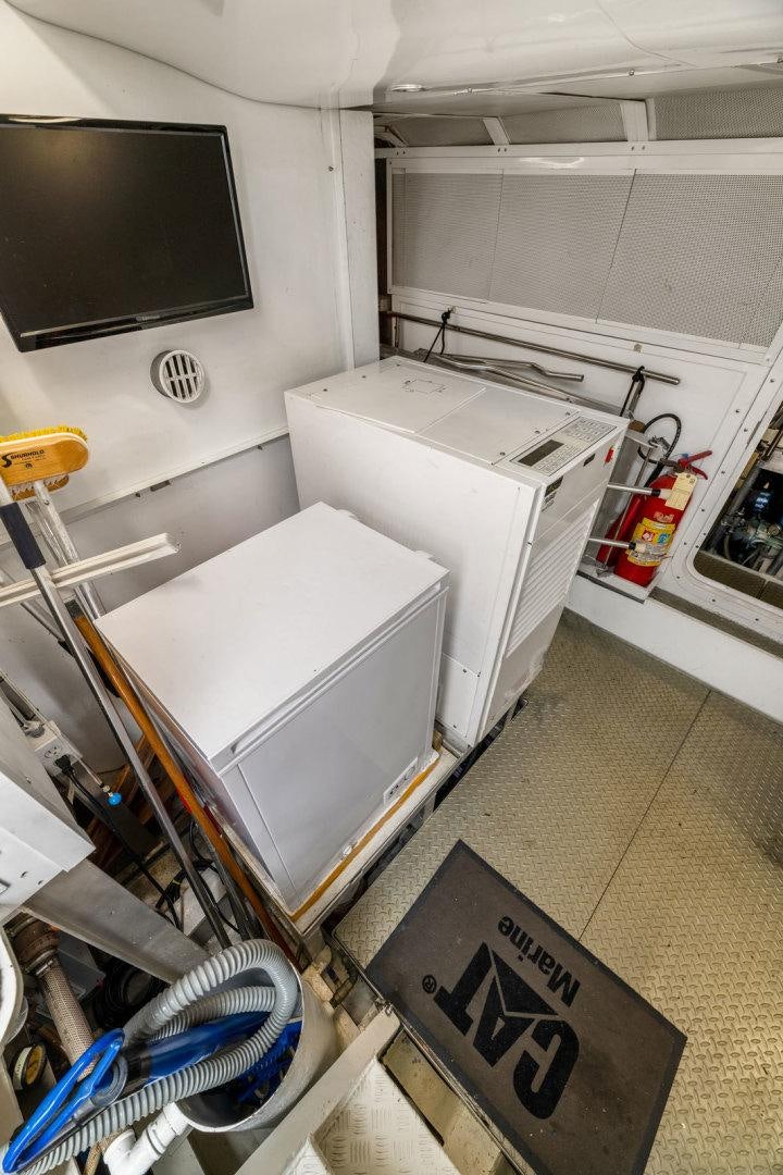 a kitchen with a tv and a sink aboard BERADA Yacht for Sale