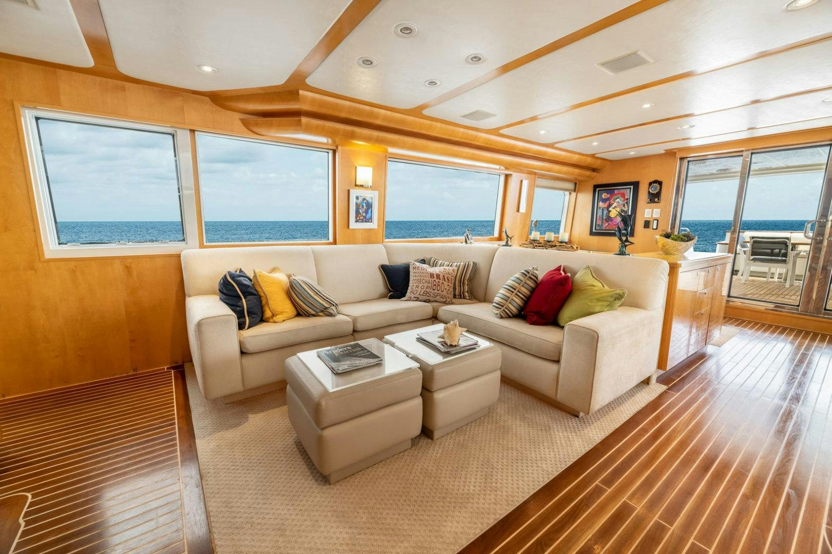 a living room with a couch and a table aboard BERADA Yacht for Sale
