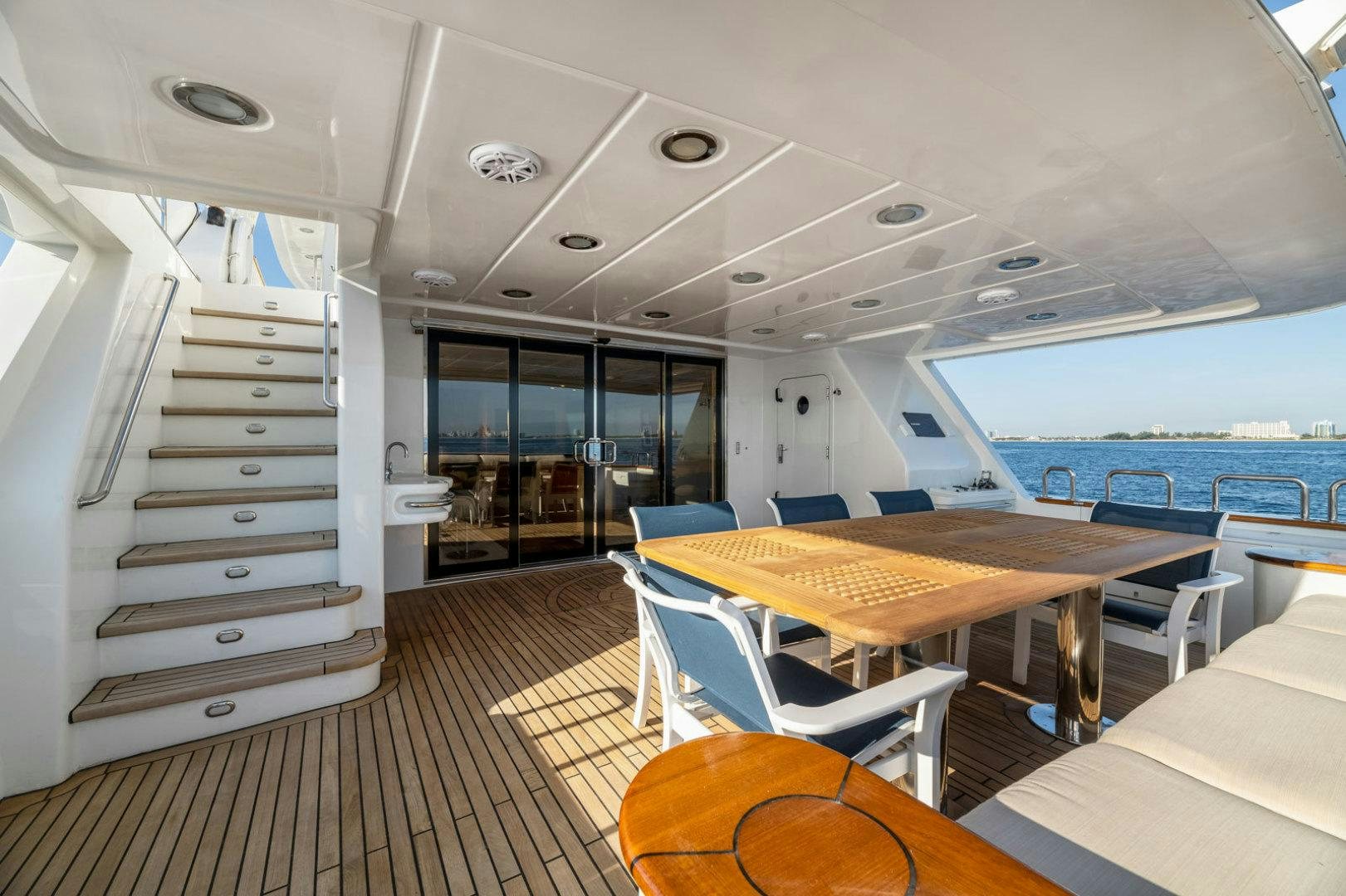 a room with a table and chairs aboard BERADA Yacht for Sale