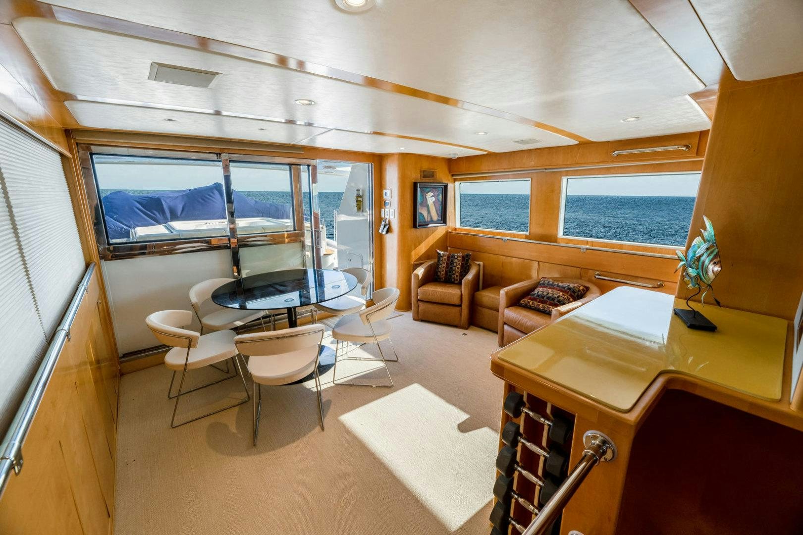 a room with a table chairs and a large window aboard BERADA Yacht for Sale