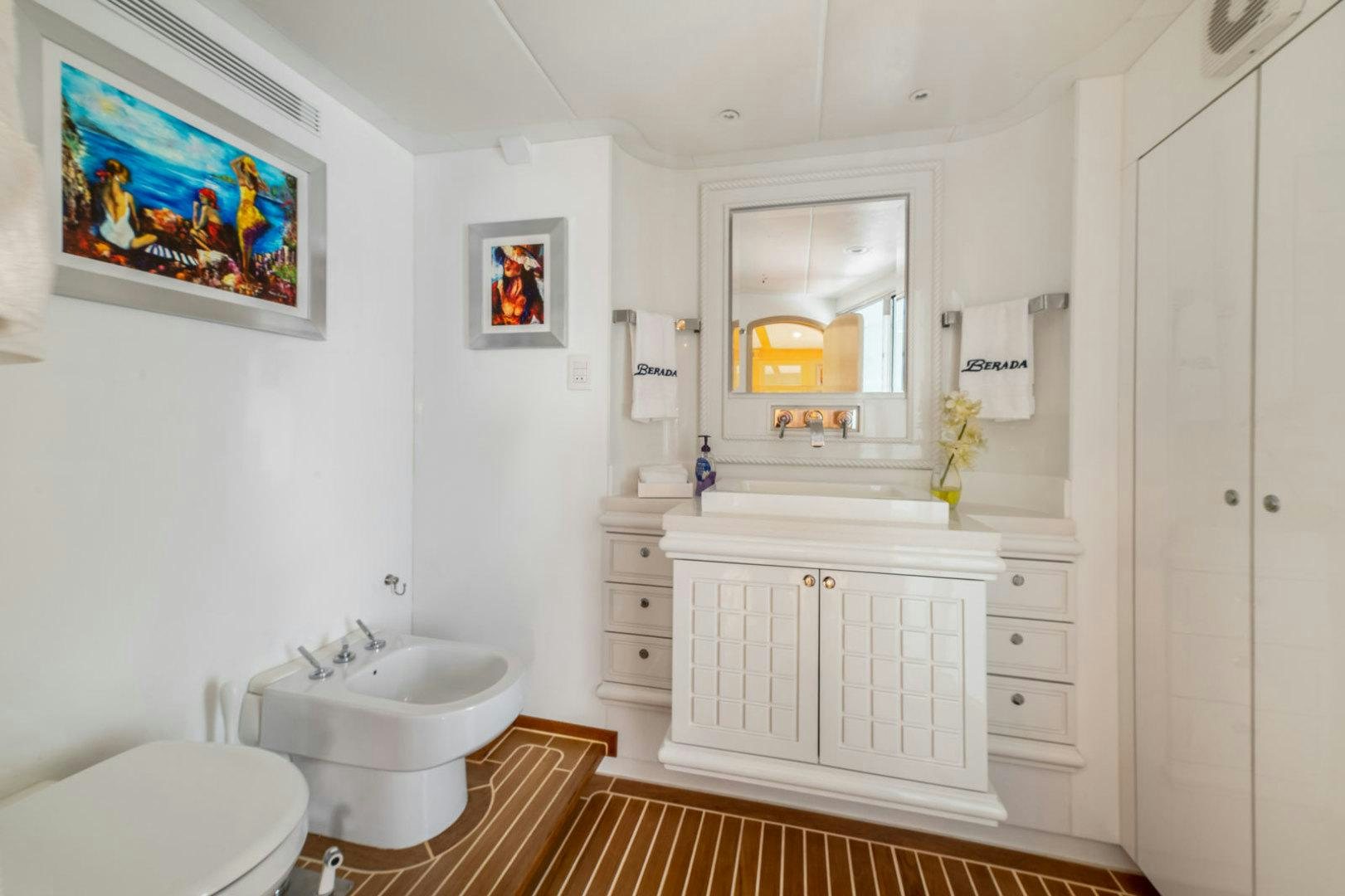 a bathroom with a sink and a mirror aboard BERADA Yacht for Sale