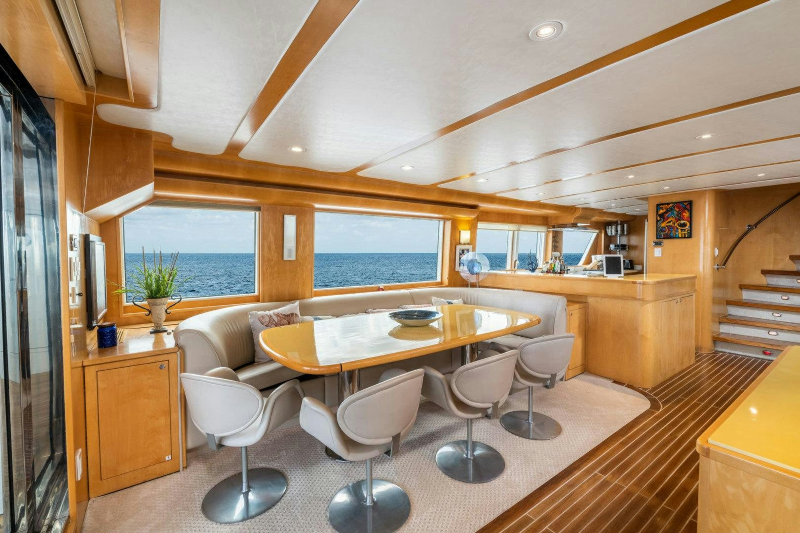 a large room with a table and chairs aboard BERADA Yacht for Sale