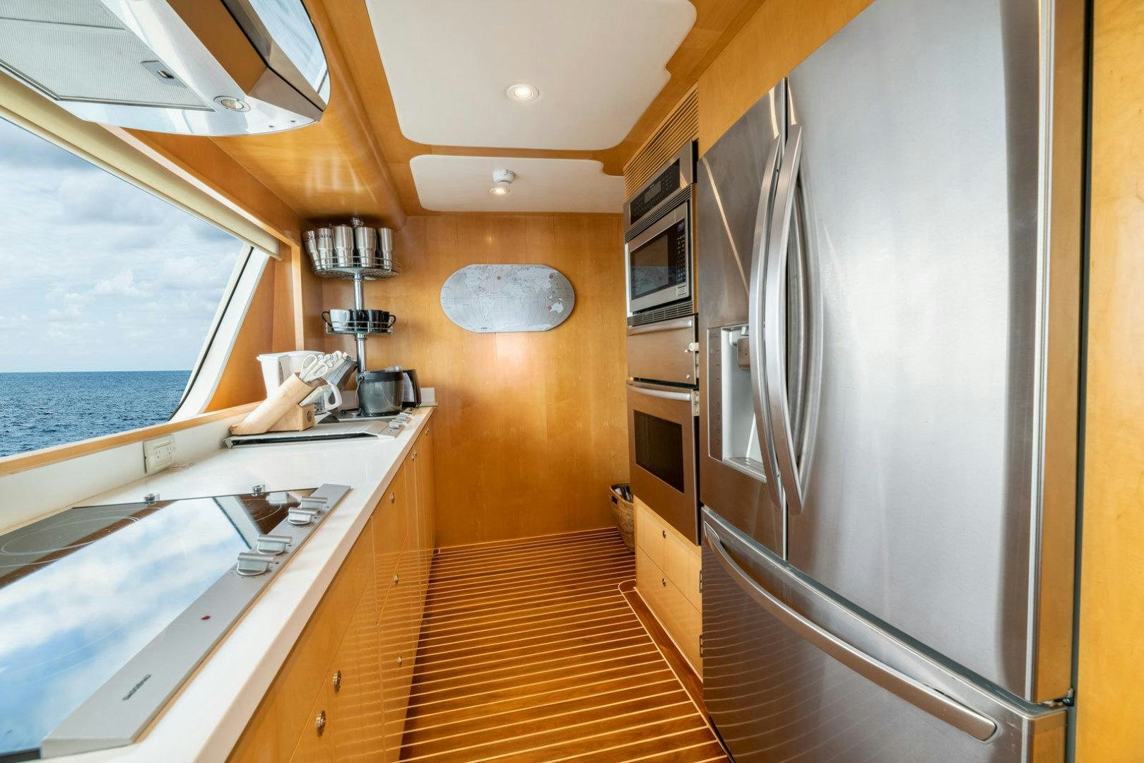 a kitchen with a large window aboard BERADA Yacht for Sale