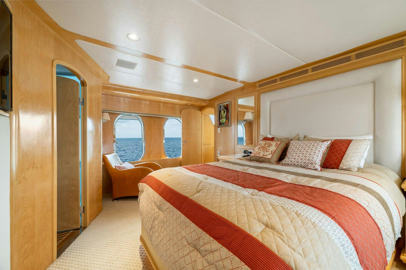 a bedroom with a bed and a window aboard BERADA Yacht for Sale