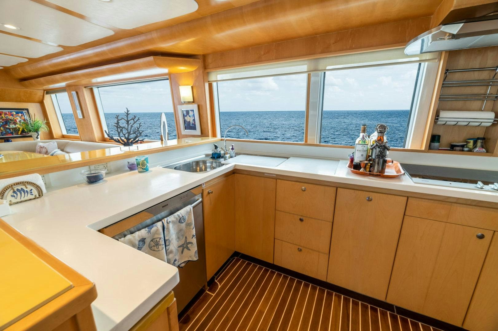 a kitchen with a large window aboard BERADA Yacht for Sale