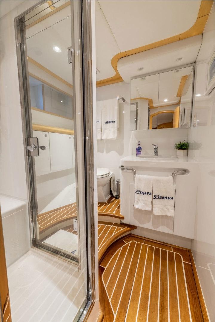 a bathroom with a glass shower aboard BERADA Yacht for Sale