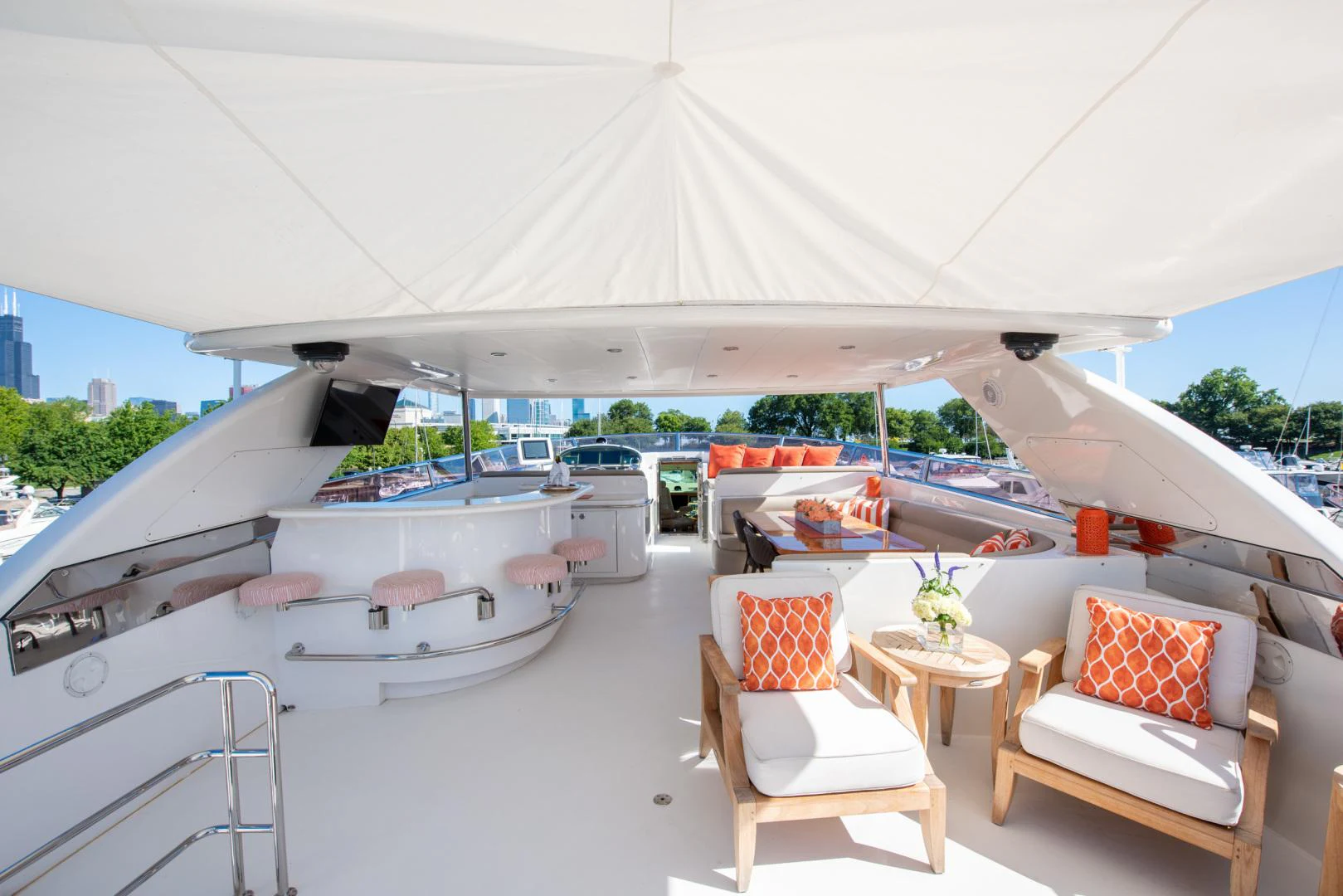 a lounge area with a lounge chair and a large white tent aboard TRITON Yacht for Sale