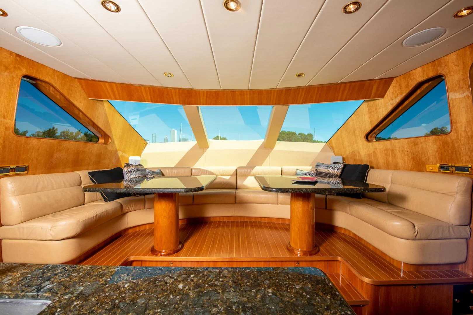 a room with a couch and a table and a window aboard TRITON Yacht for Sale