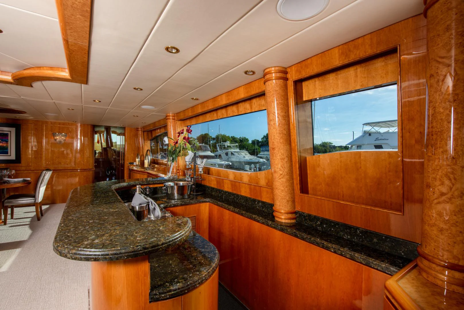 a kitchen with a bar and a large window aboard TRITON Yacht for Sale