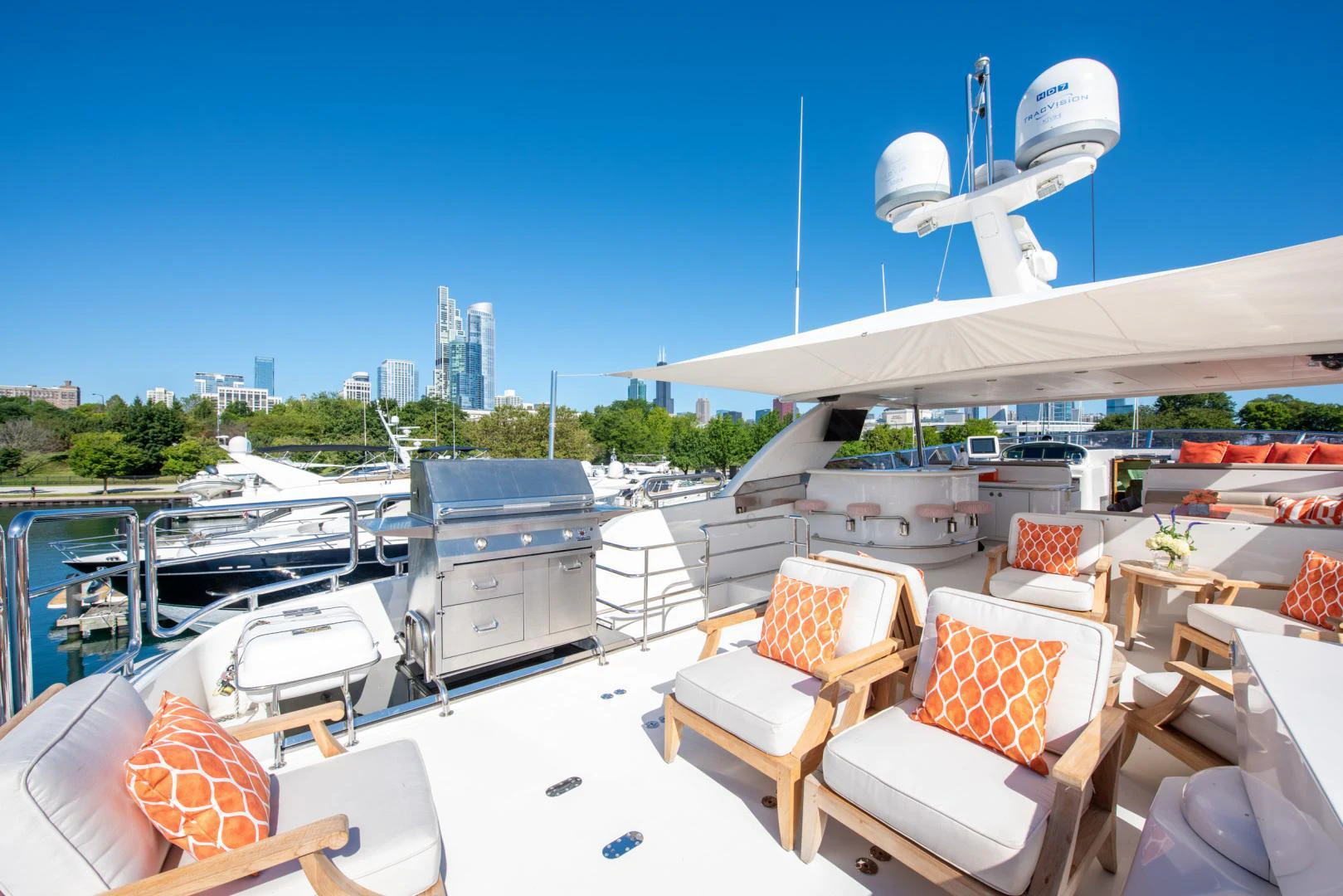 a boat dock with chairs and a plane in the background aboard TRITON Yacht for Sale