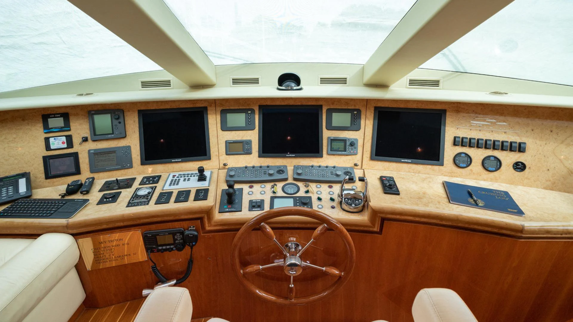 a wooden desk with a computer and other electronics on it aboard TRITON Yacht for Sale
