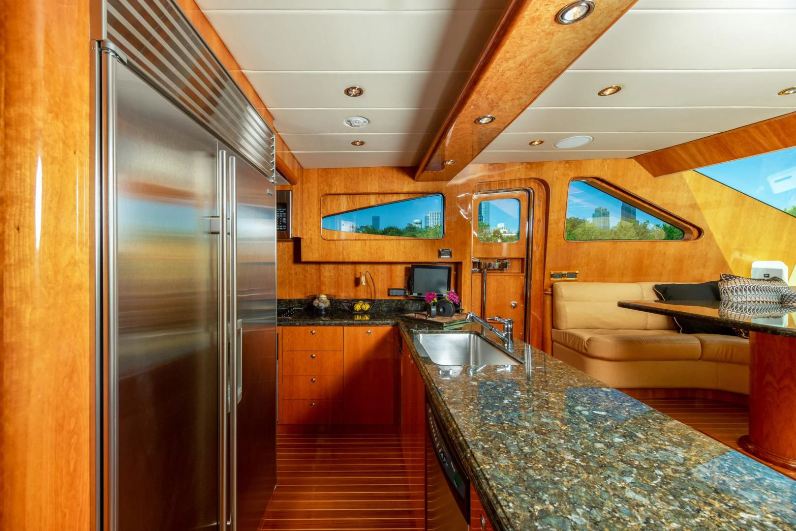 a kitchen with a large stainless steel refrigerator aboard TRITON Yacht for Sale