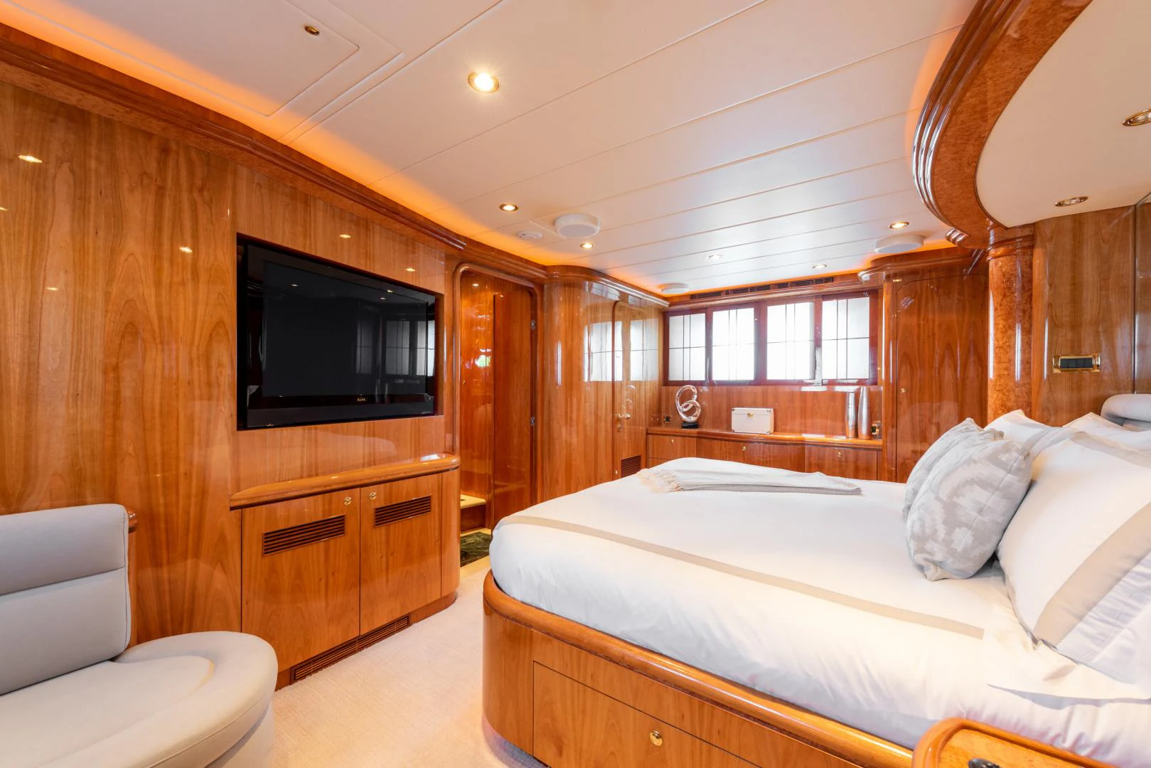 a bedroom with a bed and a television aboard TRITON Yacht for Sale
