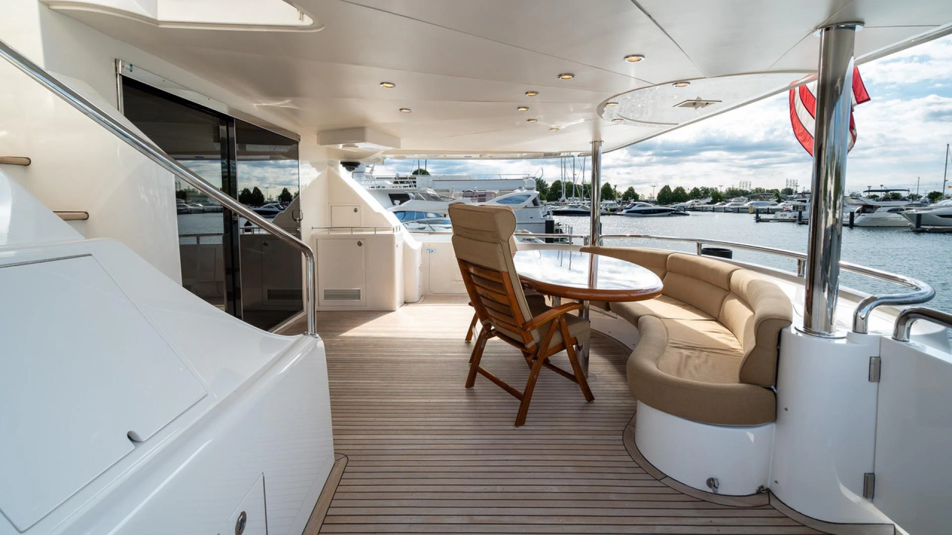 a room with a table chairs and a boat in the water aboard TRITON Yacht for Sale