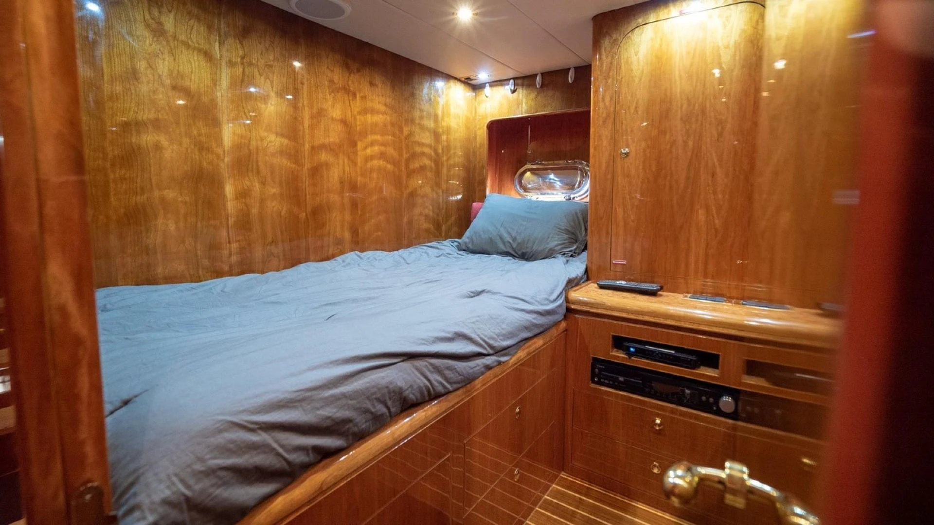 a bed with a blue sheet aboard TRITON Yacht for Sale