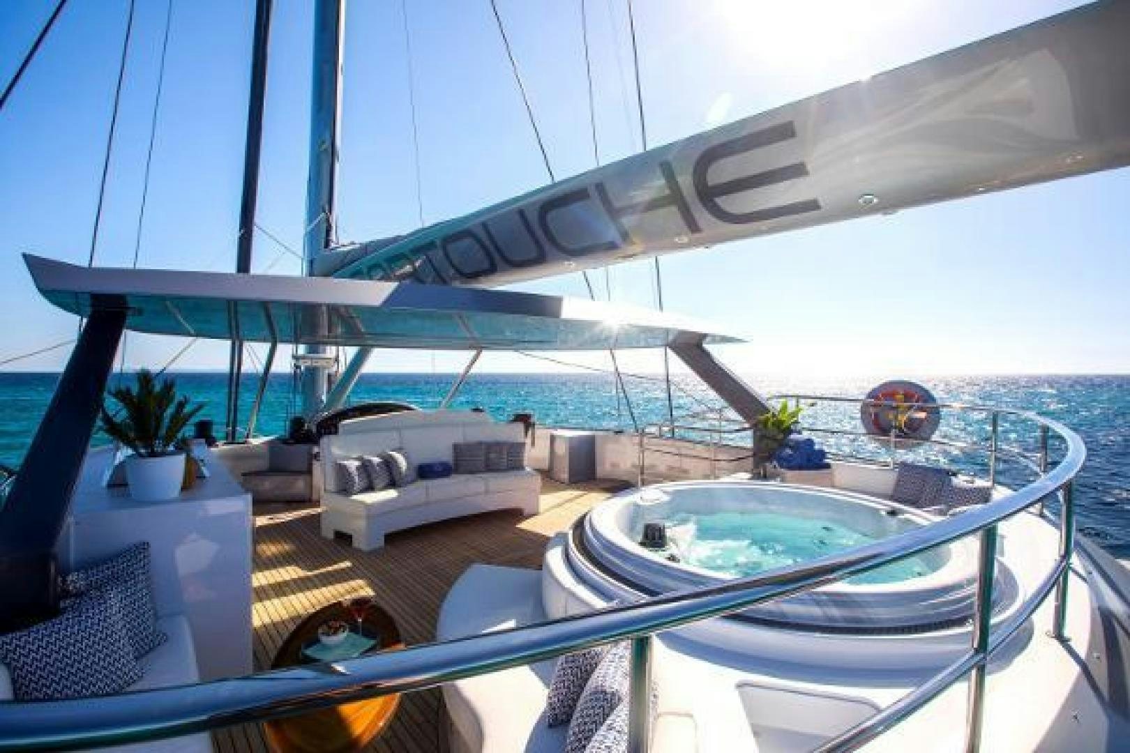 a deck with a large pool and a deck with a large deck and a large pool and plants aboard CARTOUCHE Yacht for Sale