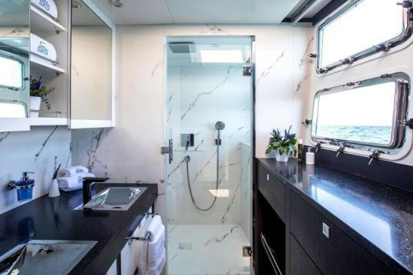a kitchen with a sink and a window aboard CARTOUCHE Yacht for Sale
