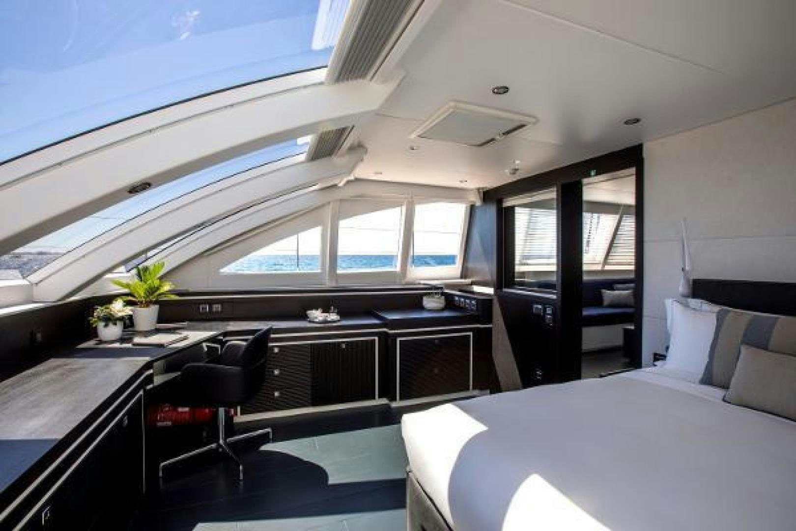 a room with a couch and a desk aboard CARTOUCHE Yacht for Sale
