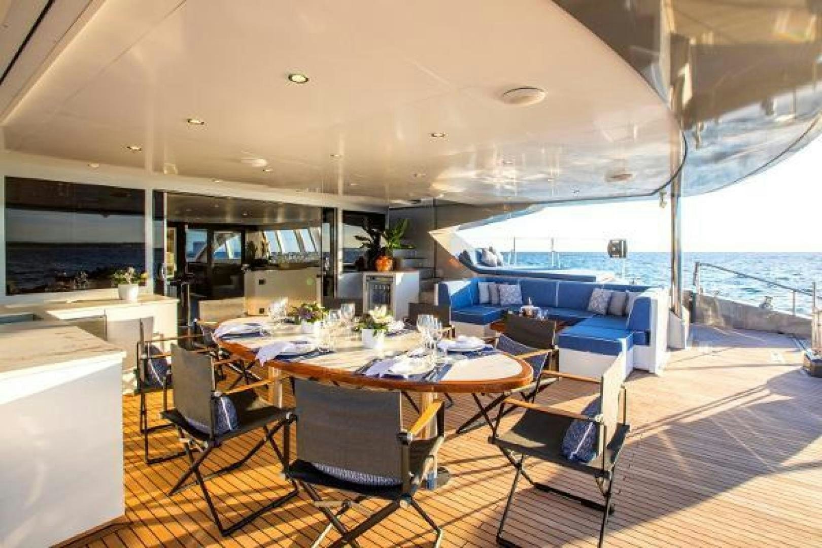 a room with a table chairs and a large window aboard CARTOUCHE Yacht for Sale