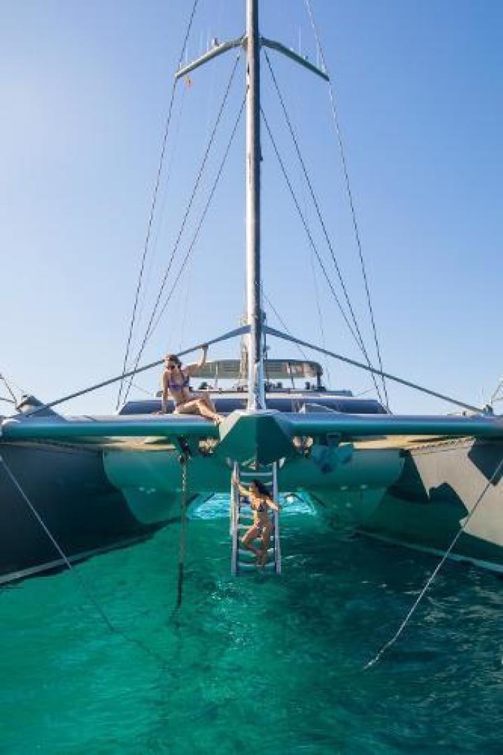 a couple of people sitting on a boat in the water aboard CARTOUCHE Yacht for Sale