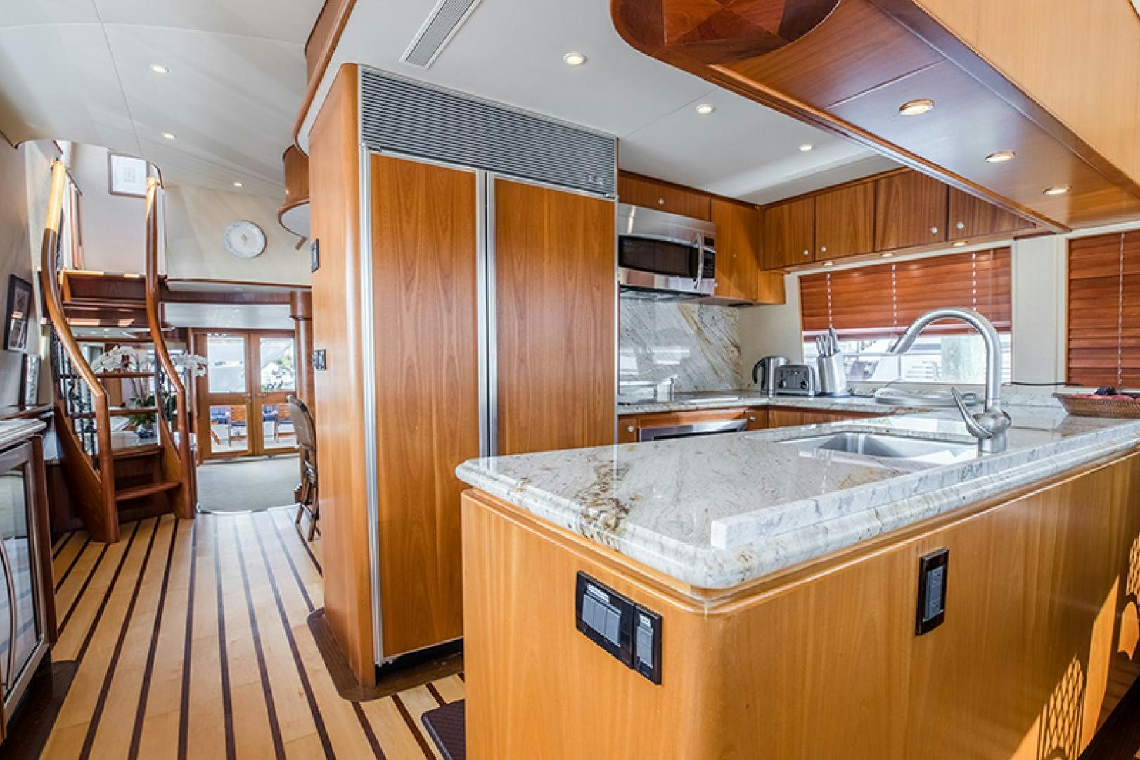 a kitchen with wooden cabinets aboard FAN TAIL Yacht for Sale