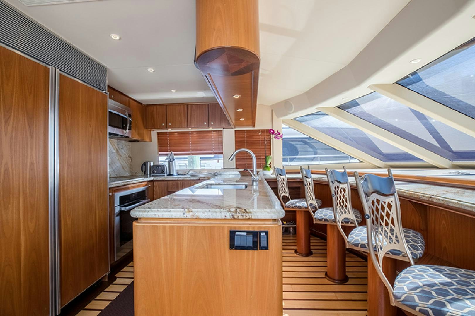a kitchen with wooden cabinets aboard FAN TAIL Yacht for Sale