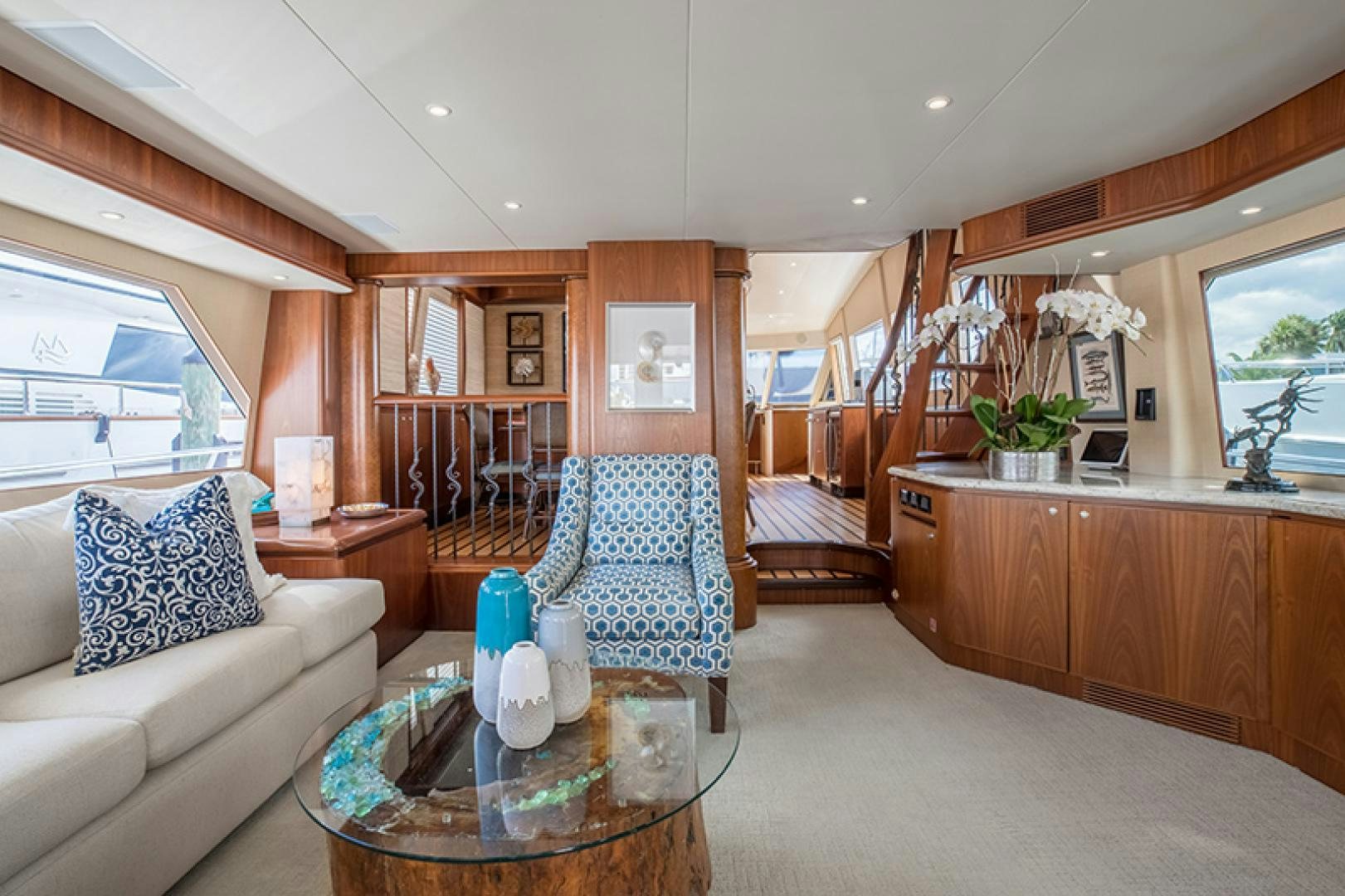 a living room with a large wood table and chairs aboard FAN TAIL Yacht for Sale