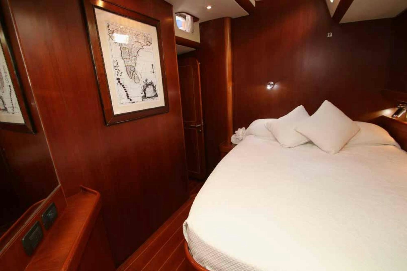 a bed with white sheets aboard MAYA RAY Yacht for Sale