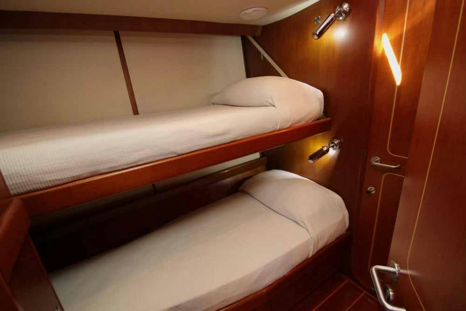 a bed with a white sheet aboard MAYA RAY Yacht for Sale