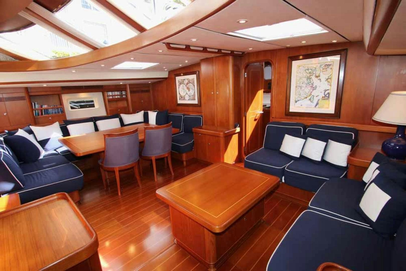 a room with a couch and a table and chairs aboard MAYA RAY Yacht for Sale
