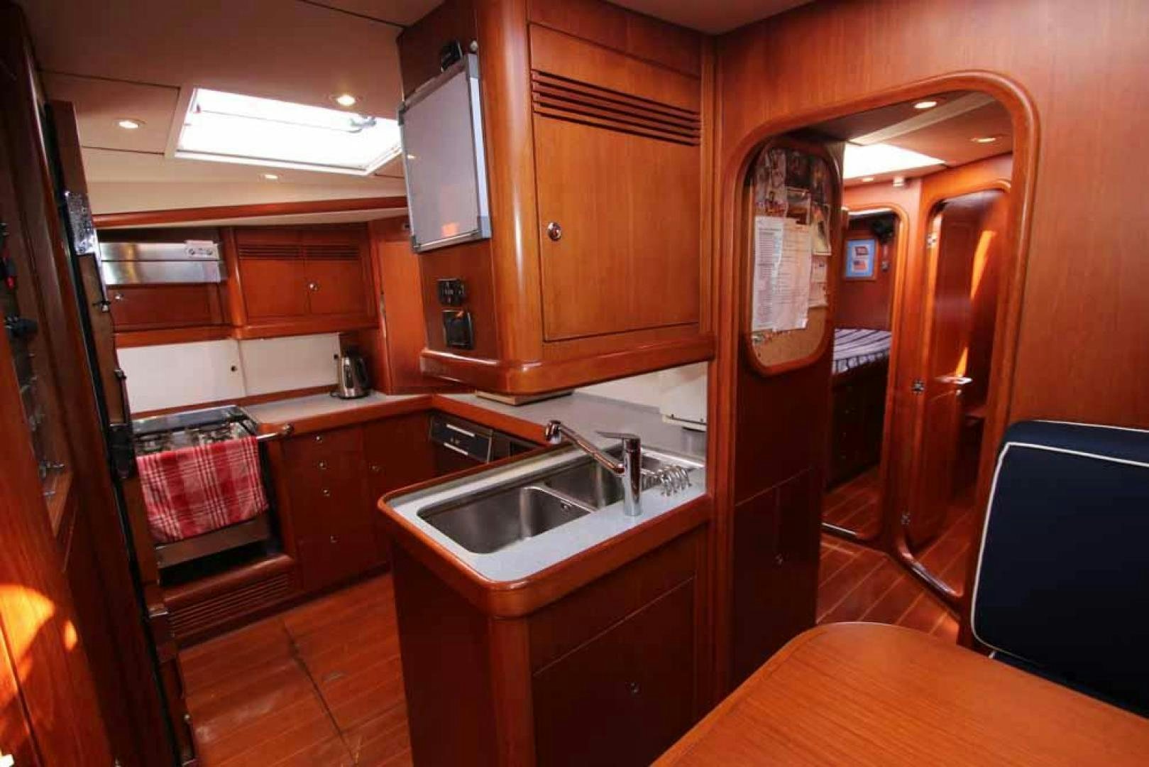 a kitchen with wooden cabinets aboard MAYA RAY Yacht for Sale