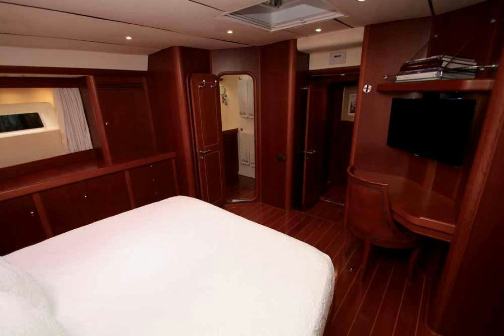 a room with a bed and desk aboard MAYA RAY Yacht for Sale
