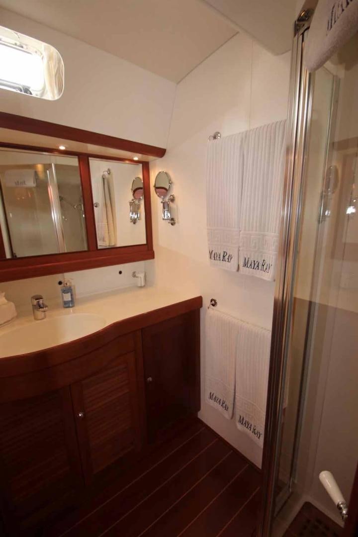 a bathroom with a mirror and a sink aboard MAYA RAY Yacht for Sale